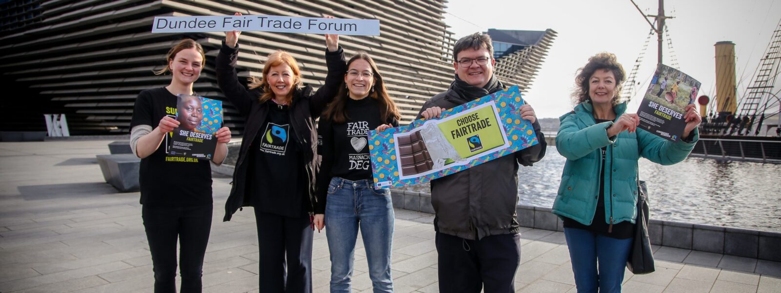 Fair trade campaigners holding fair trade posters