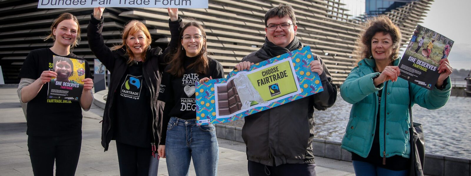 Fair trade campaigners holding fair trade posters