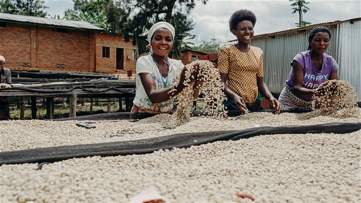 Two women with Rwandan coffee beans