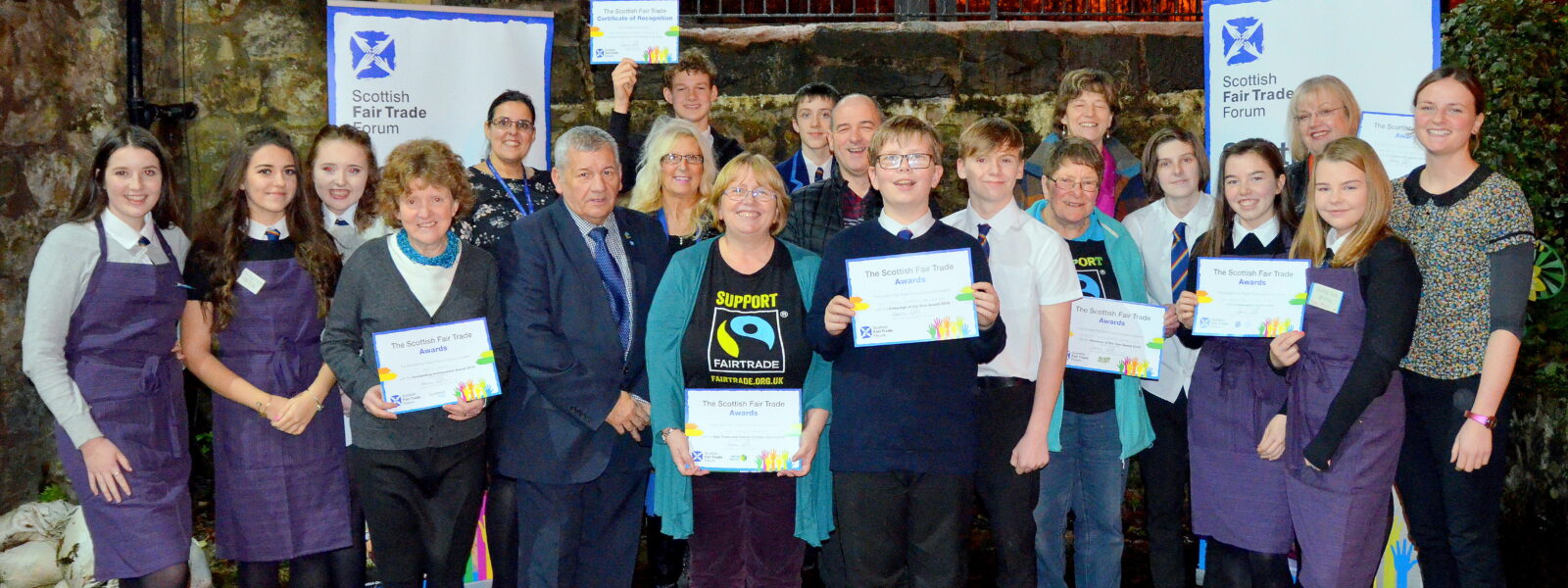 Group of children and few adults showing their Scottish fair Trade Award