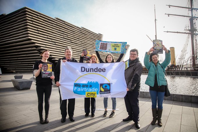 Dundee Fair Trade Group holding a 'we are a Fair Trade City' banner.