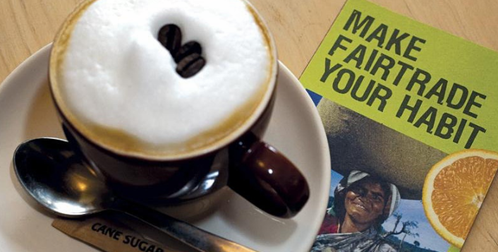 Coffee sitting beside a lefalet saying Make Fairtrade Your Habit